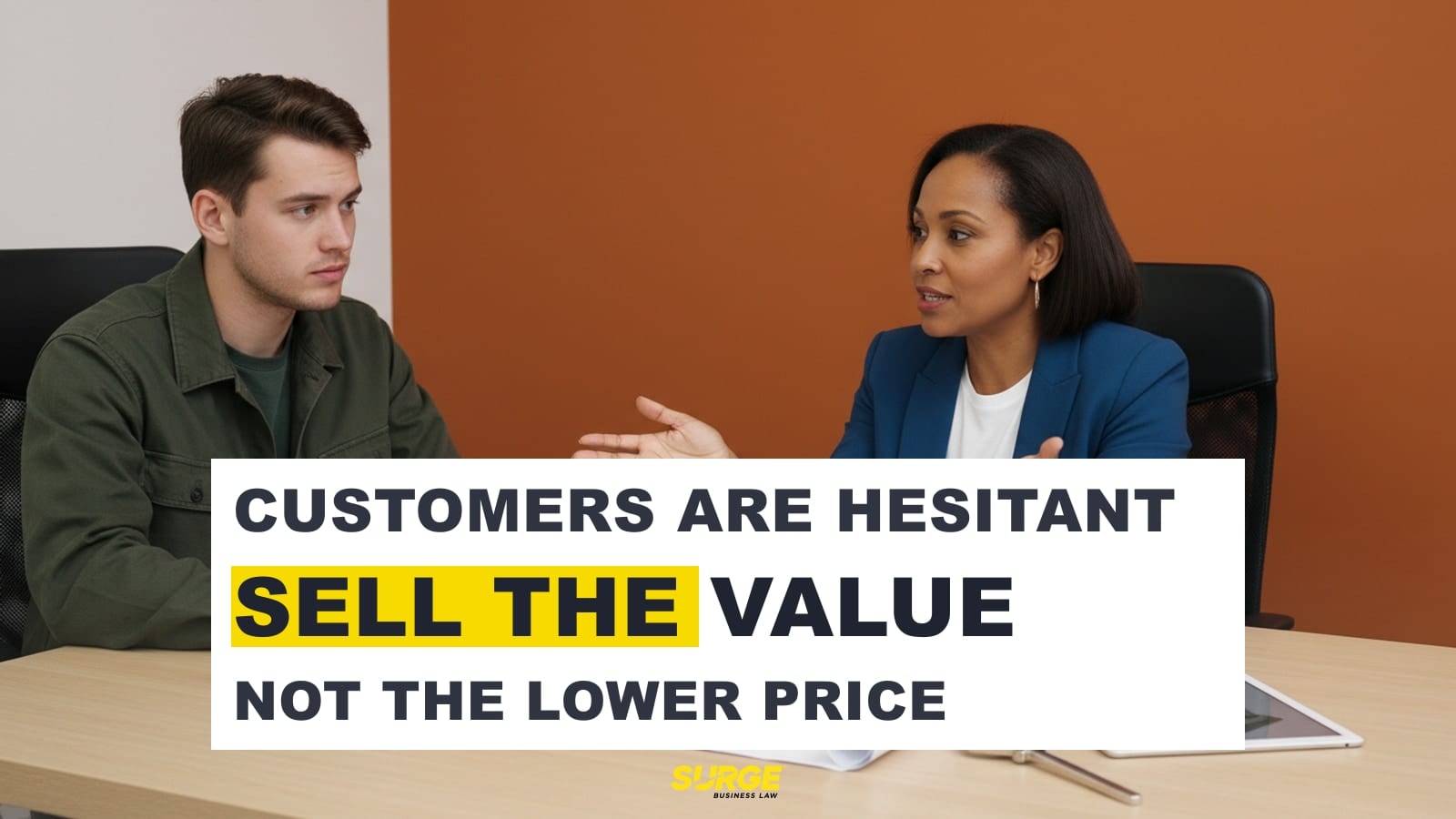 Small business owner writing a value proposition on a whiteboard while a customer waits